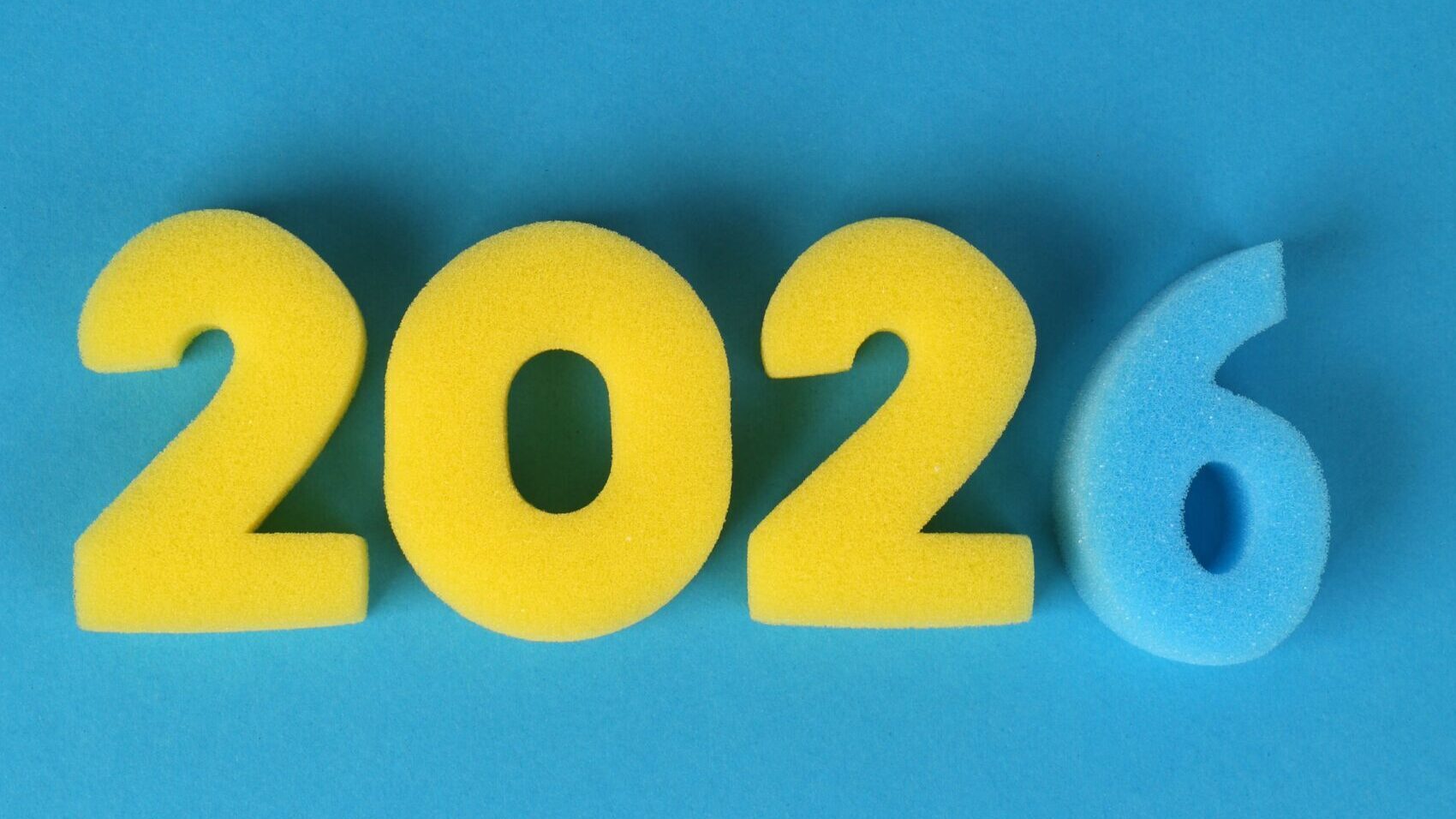 Vibrant foam numbers forming 2026 on a blue background. Perfect for New Year content.