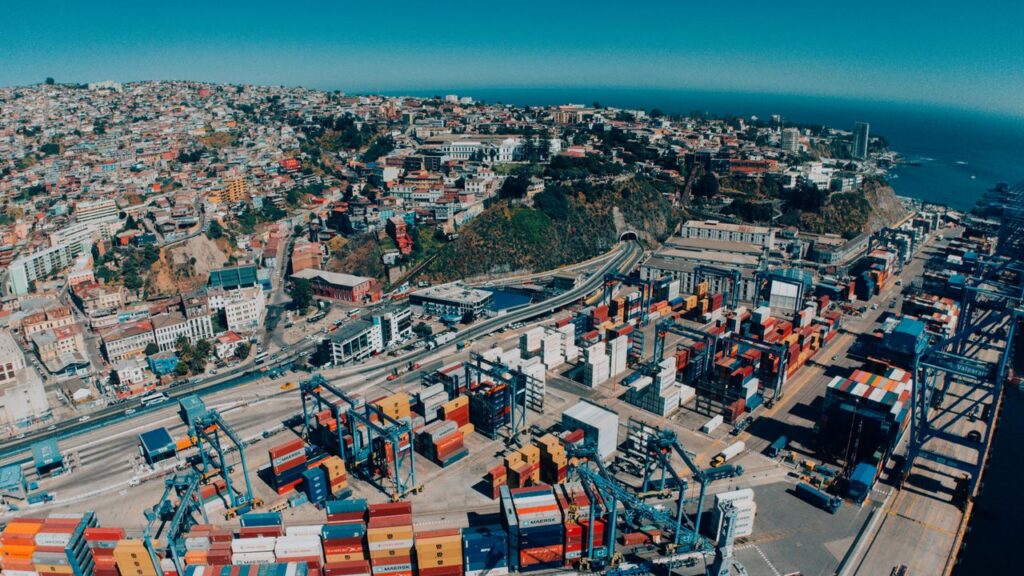 Explore a vibrant aerial view of Valparaíso, Chile, showcasing its bustling harbor and colorful hillside architecture.