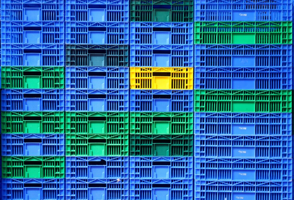 Colorful plastic crates stacked in a vibrant pattern at Tel Aviv market.